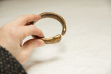 Substantial curved form of an antique African bronze bracelet with a warm, aged patina.