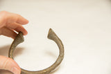 Curved end of the vintage bronze bracelet, showcasing its unique textured surface and patina.