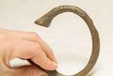 Rough texture and greenish-brown patina on the vintage African bronze bracelet segment.