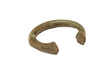 Vintage handmade African bronze bracelet with a heavy cuff shape and aged green patina.