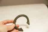 The substantial form and age-softened patina of a vintage African bronze currency bracelet.
