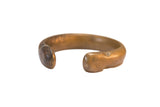 Antique African bronze cuff bracelet with a thick band and smooth, time-worn patina.