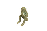 Vintage African bronze sitting monkey sculpture with a textured, green oxidized patina.