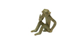 Vintage African oxidized bronze monkey sculpture in a sitting, thoughtful pose.