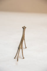 Rear view of vintage African bronze cheetah, highlighting unique texture and aged patina.