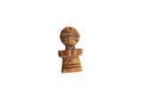 Hand-carved vintage African wooden person pendant with stylized features and incised line details.