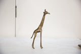Patterned bronze texture on vintage African giraffe sculpture's head and neck.