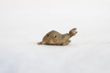 Profile view of the African bronze turtle pendant showing its raised head and textured body.