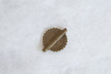 Concentric coiled pattern on the reverse side of a handmade vintage African Baule bead.