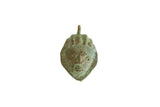 Vintage African oxidized bronze mask pendant with a textured surface and green patina.
