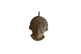 Handmade vintage African bronze mask pendant with sculpted features and a weathered texture.