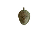 Vintage African oxidized bronze mask pendant with stylized facial features and a textured patina.