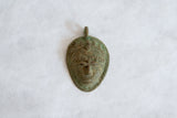 Hand-cast African bronze mask pendant with a rich, oxidized surface texture.