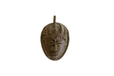 Vintage handmade African bronze mask pendant with detailed facial features and aged patina.