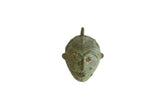 Vintage African oxidized bronze mask pendant with a weathered green patina.