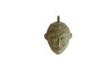 Vintage African bronze mask pendant with a weathered green oxidized patina and stylized features.