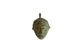Vintage African oxidized bronze mask pendant with a textured green patina.