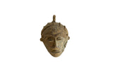 Vintage African bronze mask pendant with serene sculpted features and a textured aged patina.