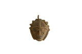 Vintage African bronze mask pendant with intricate cast details and a naturally aged patina.