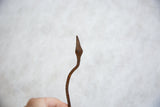 Vintage handmade African iron snake showing its textured patina.