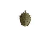 Vintage African oxidized mask pendant with a textured green and bronze patina.