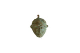Handmade vintage African mask pendant with a green oxidized patina and stylized facial features.