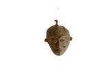 Vintage African bronze mask pendant with a handmade, textured patina and stylized carvings.