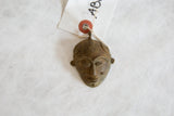 Vintage bronze African mask pendant with a rich patina and paper tag.