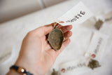 Hollow back of the vintage African bronze pendant showing its aged patina and handmade charm.