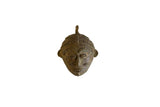 Vintage African bronze mask pendant with stylized features and a textured, aged patina.