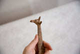 Rustic patina and texture on the head of a handmade bronze alloy giraffe.