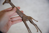 Patinaed bronze alloy body with slender legs of the vintage African giraffe.