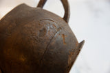 Aged dark brown wooden pitcher, highlighting the natural crack and textured surface.