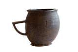 Antique African wooden pitcher, early 20th century, with dark brown handmade texture.
