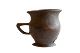 Antique dark brown African wooden pitcher with hand-carved details and aged character.