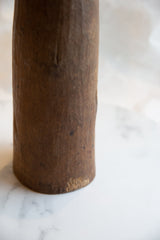 Close-up of the antique African wooden vase, highlighting dark brown wood texture and aged imperfections.