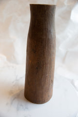 Hand-carved texture and varied brown patina on the antique African wooden vase.