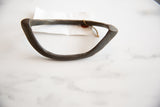 Handmade African bronze artifact with a rustic patina and original collection tag.