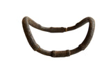 Antique African bronze curved artifact, textured with aged patina, distinct handmade form.