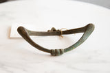Antique African bronze artifact's handmade texture and green verdigris patina.