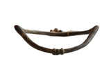 Antique African bronze curved artifact featuring weathered patina and unique handmade details.
