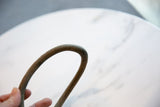 Handmade curve and rustic, time-worn patina of the antique bronze artifact.