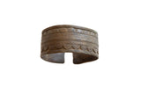 Antique African bronze cuff bracelet with incised geometric patterns and an aged patina.