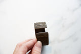 Side profile of the antique African bronze cuff, showing the bracelet's opening and etched ends.