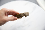 Side detail of the antique bronze cuff's raised stripe design and time-worn patina.