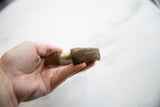 Close view of the thick, handcrafted ends of the antique African bronze cuff.
