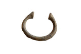 Collectible antique African bronze manilla bracelet with textured green-brown patina.