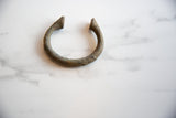 Textured antique African bronze alloy manilla cuff with aged green patina and pointed end.