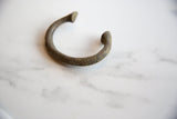 Antique African bronze manilla cuff bracelet's textured patina.