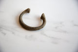 Textured surface and deep patina on the antique African copper alloy bracelet.